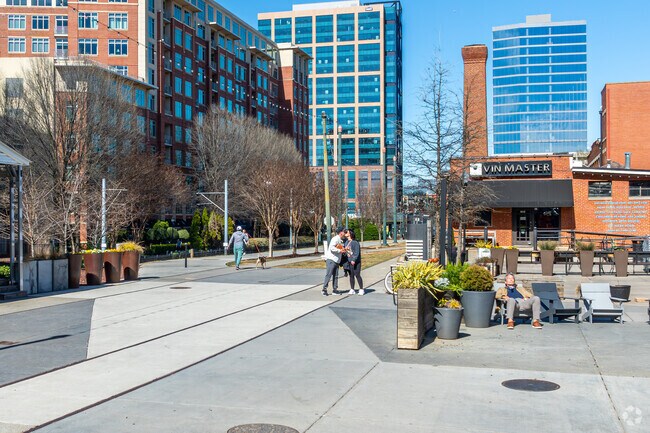 Locals enjoy the patio and walking path behind Atherton Mills in Dilworth.