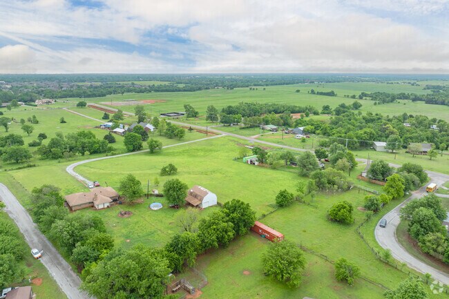 Own a home on a large plot of land in West Mustang.