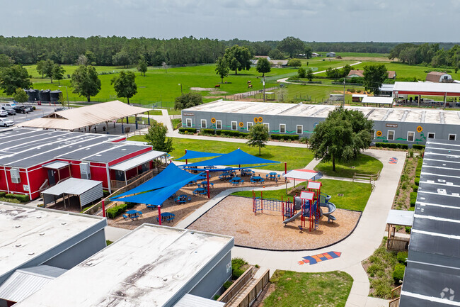 Kids enjoy playing on the play area at Academy At The Farm .