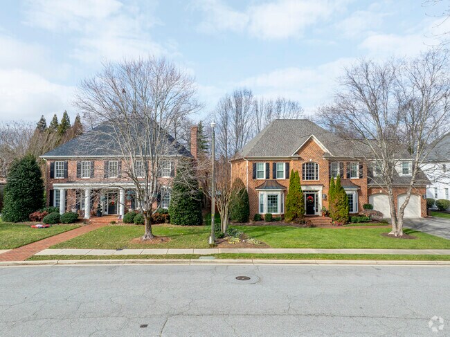 A French Country style home next to a craftsman home in The Bluffs.