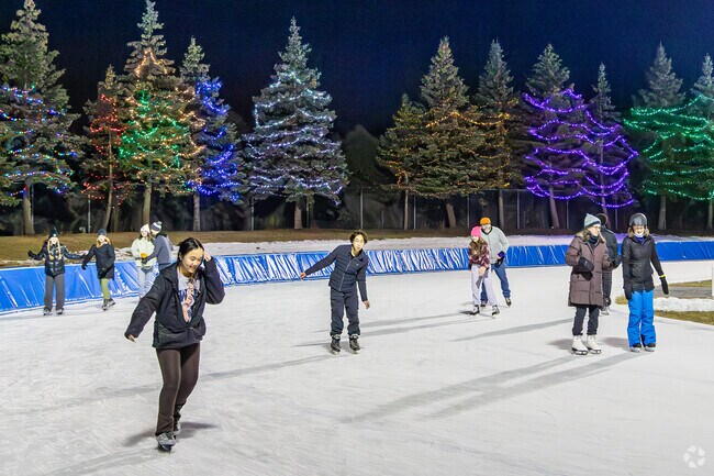 Attendees at Roseville's New Year's Eve on Ice skate around the festively lit oval.