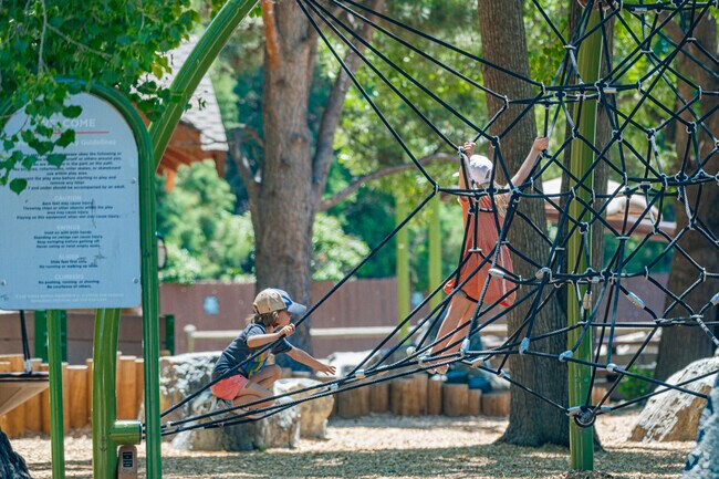 Children play at Niwot Children's Park on a warm summer afternoon.