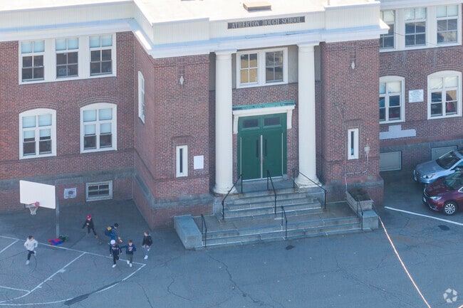 Students play outside the main entrance to Atherton Hough Elementary School in Quincy, MA.