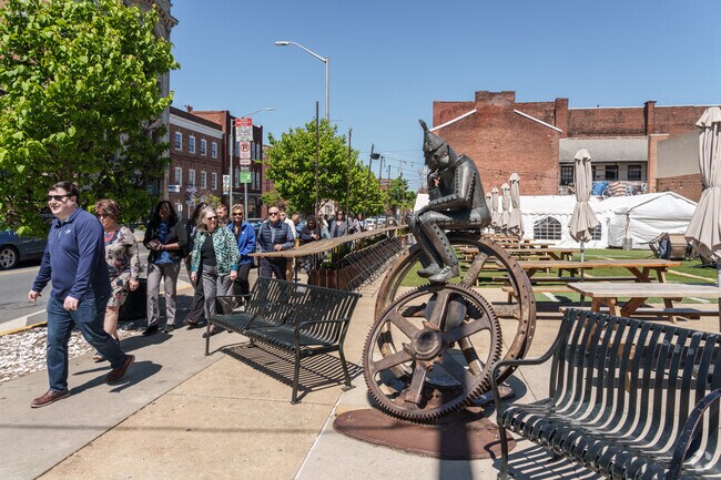 A Tin Man sculpture reminds these visitors of Northeast York’s industrial heritage as they tour the downtown area.
