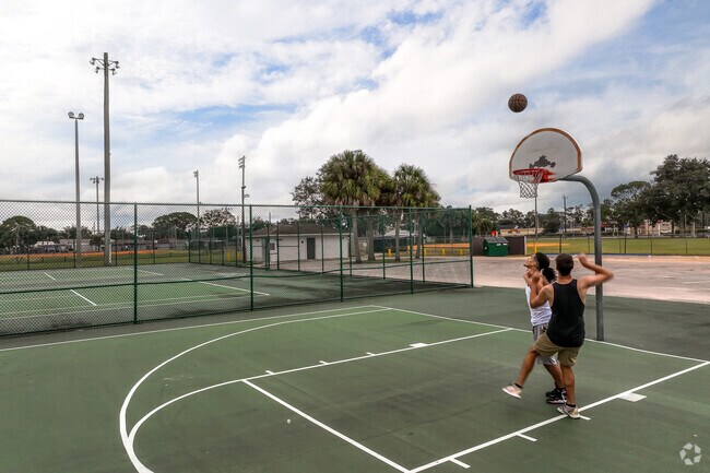 Two locals enjoying a pick up game of basketball at Port St. John's Fay Park.