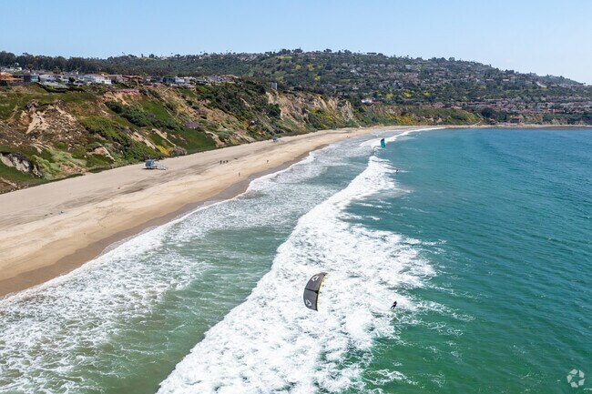 Have fun windsurfing with friends off the sunny Torrance Beach coastline.