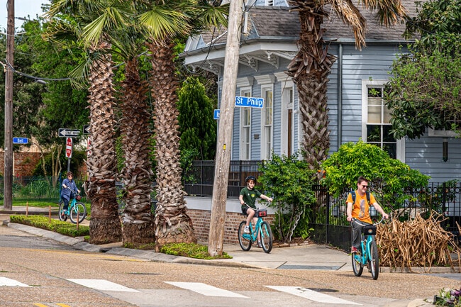 Families in Bayou St John enjoy riding bikes together.