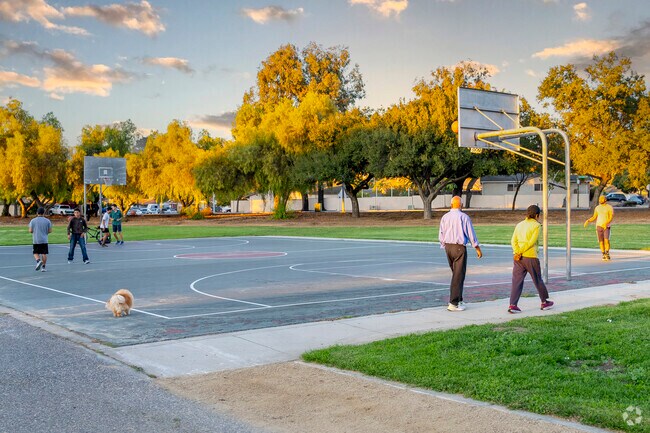 Join friends for a quick game of basketball at Silver Creek Linear Park in vibrant San Jose.