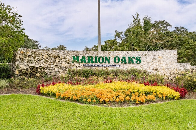 An impressive entrance sign surrounded by colorful flowers in Marion Oaks.