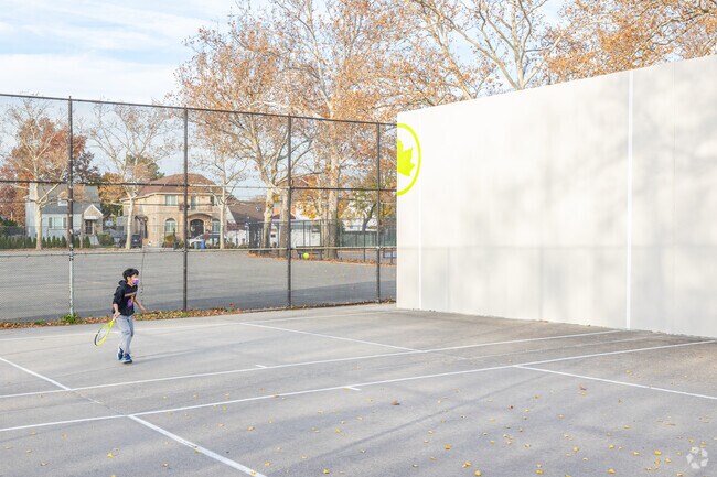 Kids learn tennis at Utopia Playground near Pomonok.