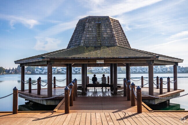 People enjoy the gazebo at the lagoon in Treasure Isle.