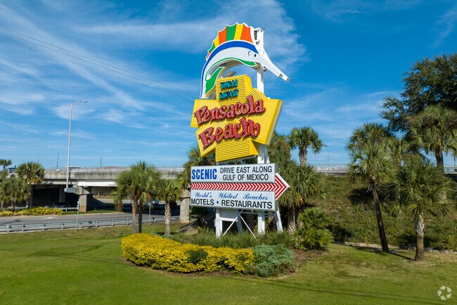 Travelers are greeted by the colorful and iconic Pensacola Beach sign.