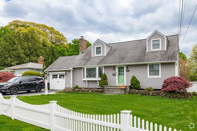 The Doghouse dormers on this Cape Cod in Halesite add extra space and charm.