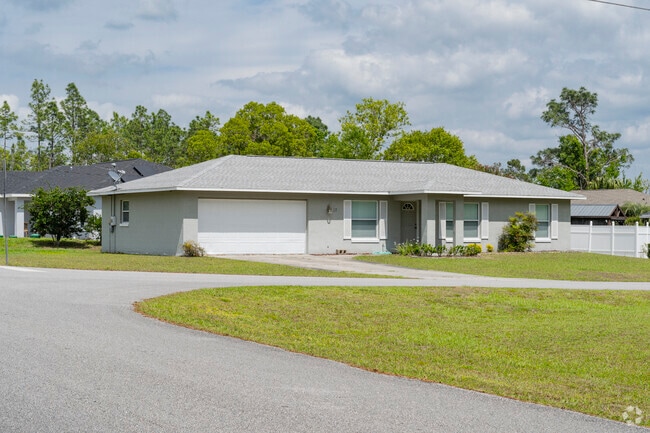 This single family Silver Spring Shores home sits on a corner lot and features a spacious yard.