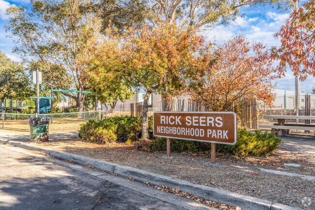 Rick Sears Neighborhood Park offers a peaceful green space for relaxation and play.