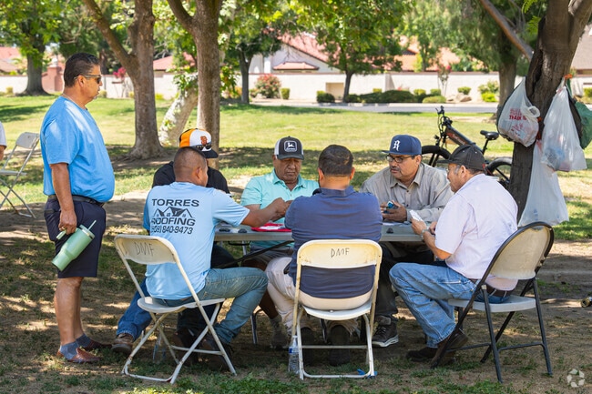 A group of friends enjoys a game of cards at the Lions Town & Country Park.