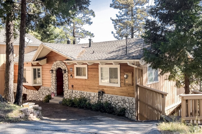 Stone and wood accents warm up this cozy rustic cabin in Crestline.