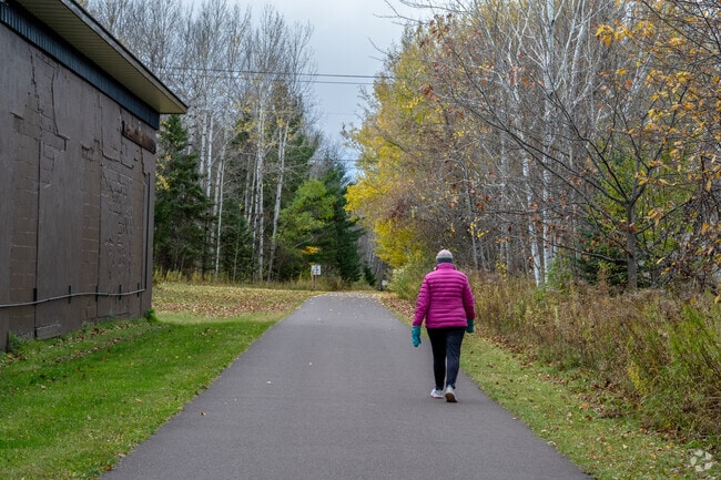 Ironwood walkers trek the Iron Belle Trail through Ironwood Historic Depot Park.