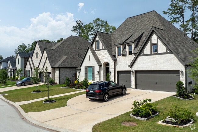 Beautiful Tudor homes with high-pitched roofs line a street in The Highlands.