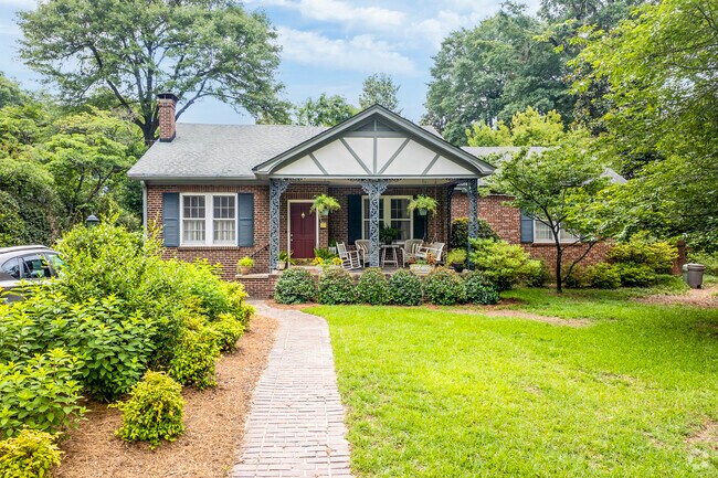 The porch on this Craftsman bungalow seems to greet guests as they approach on the walkway.