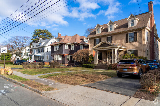 A row of single and multifamily homes line the same street in West End.