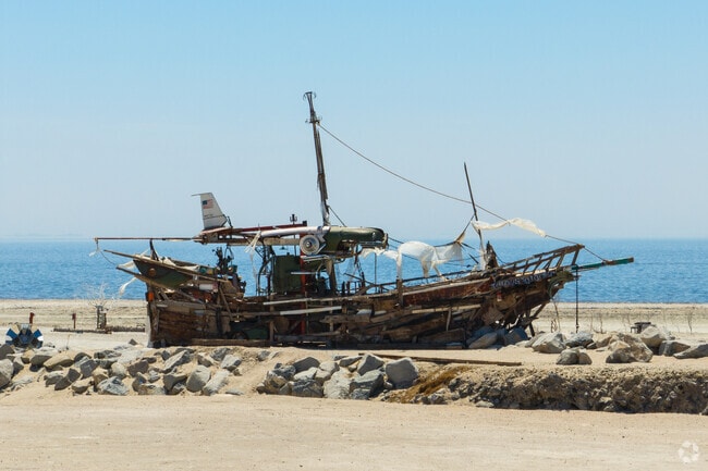 Abandoned boats and salt-crusted sculptures line the shores of Bombay Beach.