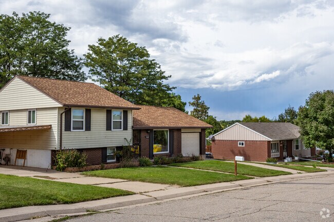 A split level home with brick details and a two car garage in Parkway Estates, Arvada, Colorado.