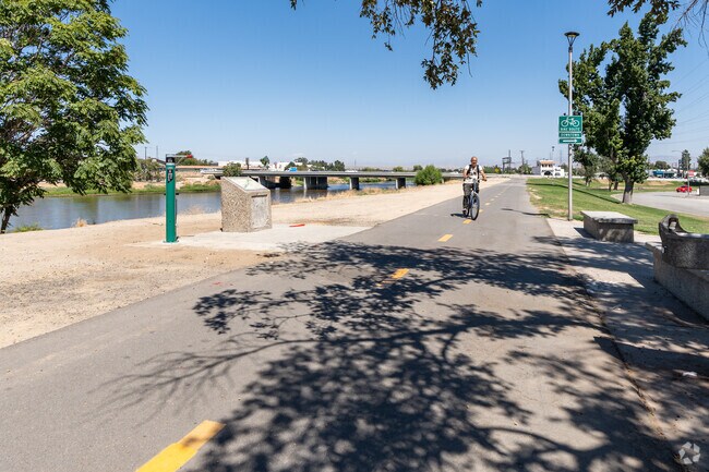 A man rides his bike along the Kern River Parkway Bike Trail in Downtown Bakersfield.