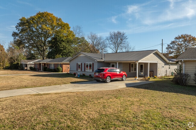 Delano Park homes typically feature carports or driveway parking.