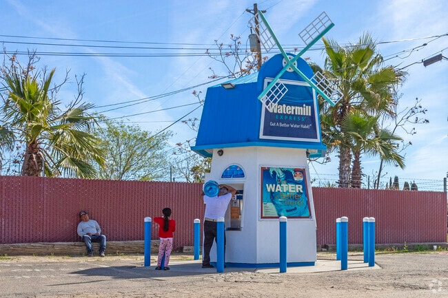 A family collects purified water from a watermill in Mendota.