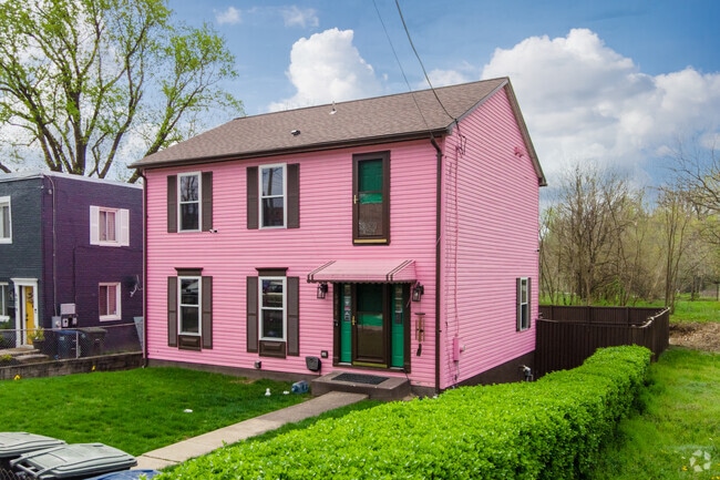 A large, hot pink Colonial demands the attention of anyone passing by.