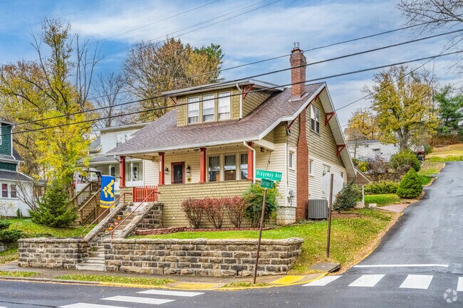 A beautiful home on a corner lot with stone walls stands out in the Woodburn neighborhood.