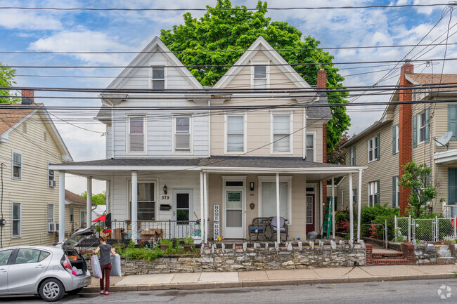 Twin farmhouses with wrap-around porches are timeless and atttractive in Enhaut.