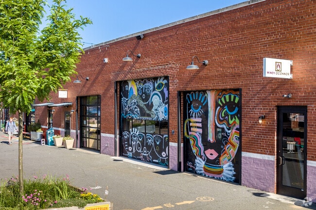 Murals appear on the retail buildings at Camp North End in the Druid Hills area of Charlotte.