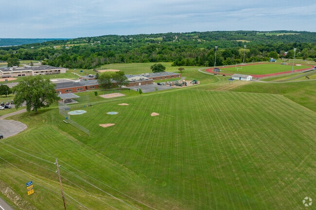 Raymond C. Buckley Elementary School features a large baseball field for students.