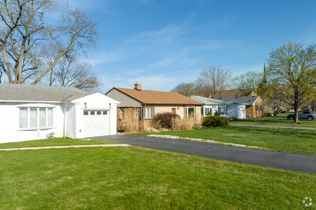 A Minimalist Ranch-Style Home is nestled in between similar home styles in Forest Hill.