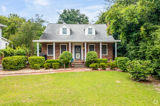 This Cape Cod is nicely framed with lush trees.