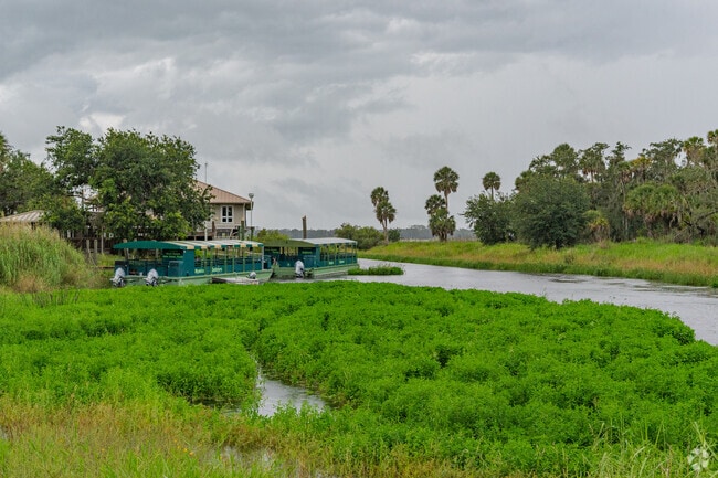 Boats float on a coastal river near Myakka Valley Ranches.