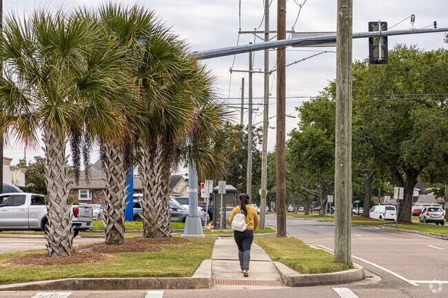 A young lady walks along the West Esplanade Ave neutral ground  in the Pontchartrain Shores neighborhood of Metairie