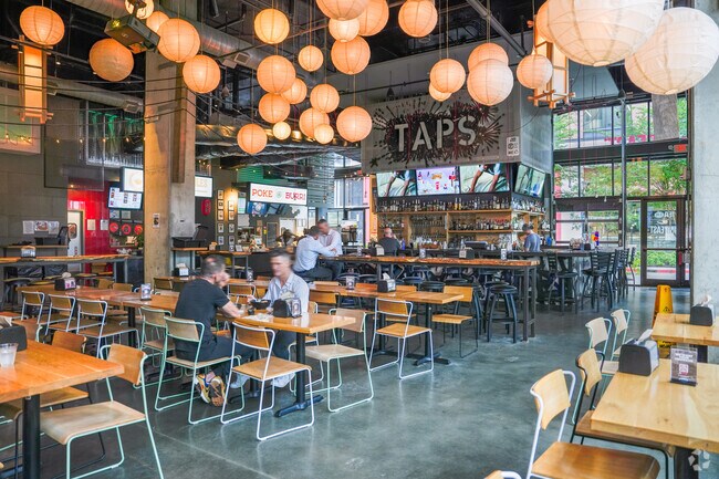 Ph'east features a vibrant, industrial-style food court surrounded by various Asian vendors.