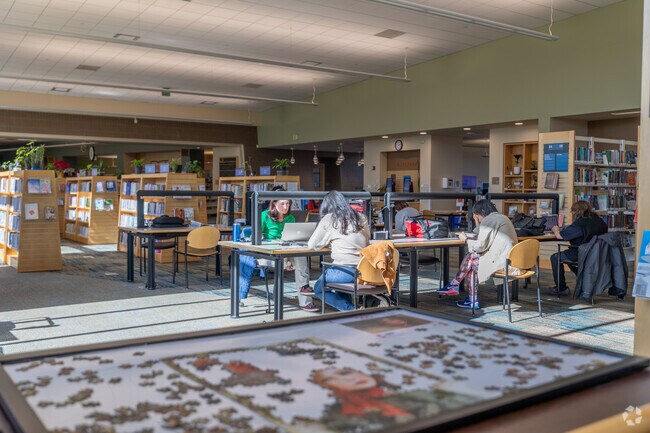 Bright, welcoming study spaces inside the Foster City Library in Treasure Isle.