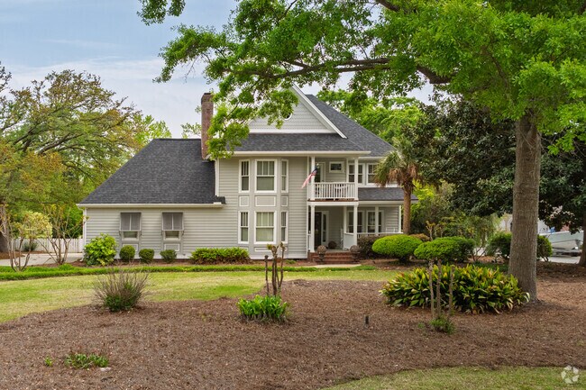 A custom-built home in Greenville Loop showcases a well-manicured lawn.
