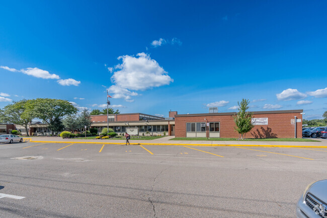 The staff parking lot and main entrance of John F Kennedy Intermediate School.