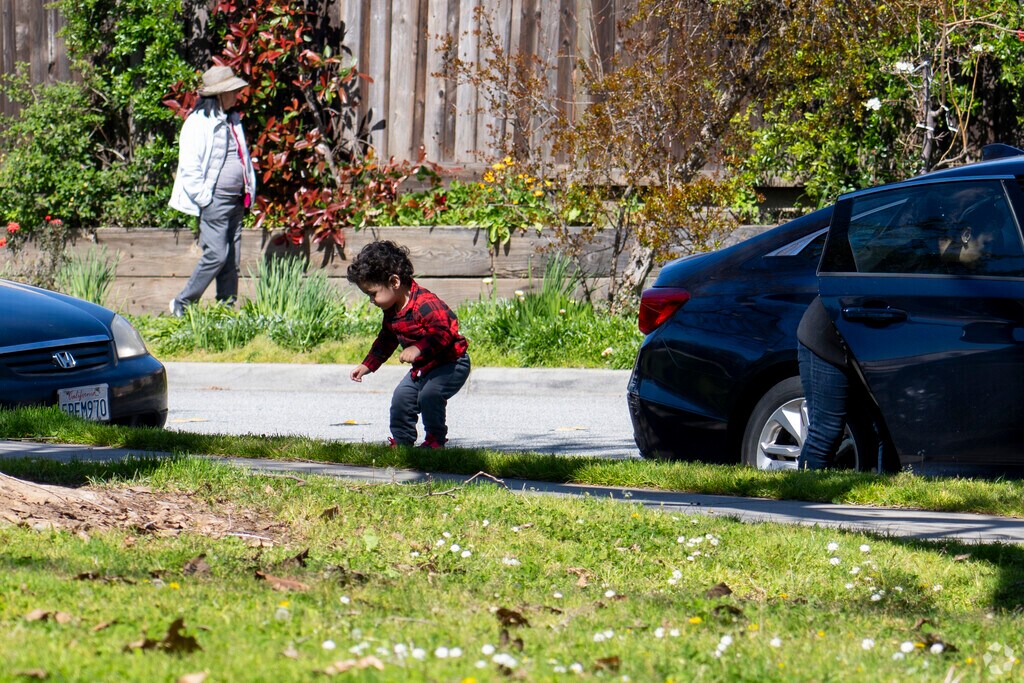 A kid enjoying the grass in the Branham-Kirk neighborhood.