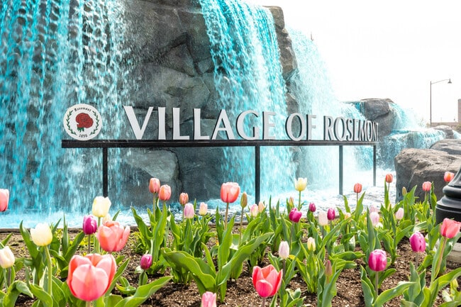 Picturesque Fountain Comprised of Large Rocks, Creating Multiple, Cascading Waterfalls With Village of Rosemont Sign.