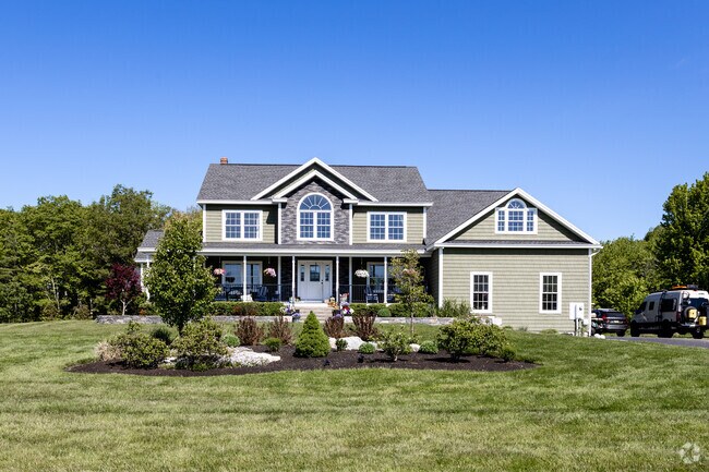 A modern two-story home with a front porch can be found in North Biddeford.