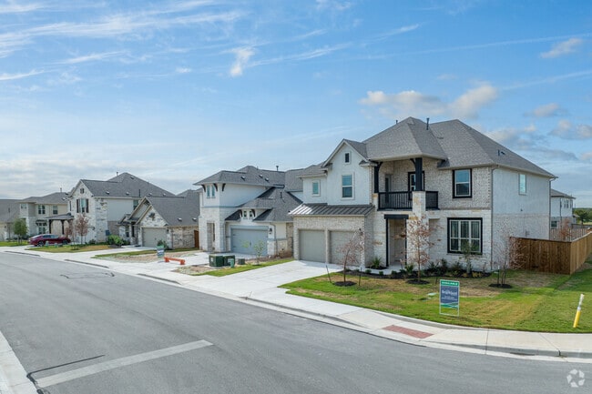 Diverse homes in HighPointe feature various stone and brick facades, showcasing variety.