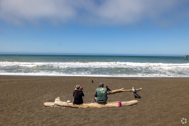 A couple relaxes on Sharp Park Beach near Pacific Heights.