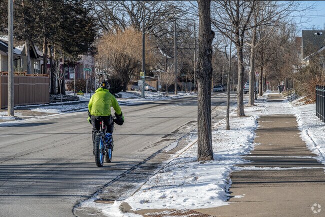Bikers pass by Longfellow Park in all seasons.