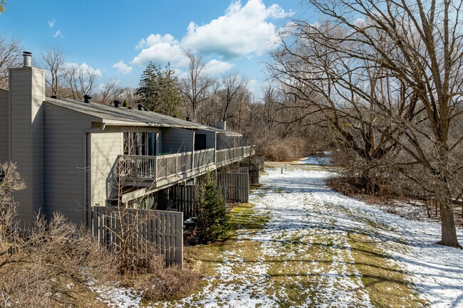 Condos at Geddes Lake feature stacked patios and balconies that back up to the lake.
